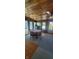 Sunroom with wooden walls and flooring, a ceiling fan, and an exterior glass door at 3348 W 800 N, Fairland, IN 46126