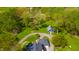 Aerial view of a two-story home with a long driveway, guesthouse, and a lush, green lawn at 3405 W 8Th Street Rd, Anderson, IN 46011