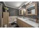 Elegant bathroom features a double vanity, marble countertop, and stylish floral wallpaper at 3405 W 8Th Street Rd, Anderson, IN 46011