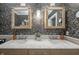 Bathroom featuring a double vanity with marble countertop, framed mirrors, and decorative wallpaper at 3405 W 8Th Street Rd, Anderson, IN 46011