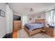 Comfortable bedroom featuring a wooden bed, a wooden dresser with TV, and natural light at 3405 W 8Th Street Rd, Anderson, IN 46011