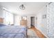 Light-filled bedroom boasts hardwood floors, charming decor, and ample natural light at 3405 W 8Th Street Rd, Anderson, IN 46011