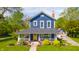 Charming two-story home with a welcoming front porch, yellow door, and beautifully landscaped front yard at 3405 W 8Th Street Rd, Anderson, IN 46011