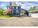 Two-story house with a brick chimney, garage, and well-maintained yard at 3405 W 8Th Street Rd, Anderson, IN 46011