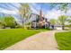 Charming two-story home with a well-manicured lawn, inviting porch, and a detached garage at 3405 W 8Th Street Rd, Anderson, IN 46011