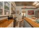 Charming kitchen featuring an island with a butcher block top, open shelving and a tin tile ceiling at 3405 W 8Th Street Rd, Anderson, IN 46011