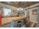 Eat-in kitchen features stylish island seating, white cabinetry, and a vintage Coca-Cola refrigerator at 3405 W 8Th Street Rd, Anderson, IN 46011