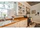 Bright kitchen features white cabinetry, wooden countertops, and modern appliances at 3405 W 8Th Street Rd, Anderson, IN 46011