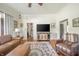 Comfortable living room featuring leather furniture, area rug, a TV, and abundant natural light at 3405 W 8Th Street Rd, Anderson, IN 46011