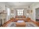 Inviting living room features a decorative fireplace, comfortable seating, and natural light from large window at 3405 W 8Th Street Rd, Anderson, IN 46011
