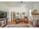 Relaxing living room showcases hardwood floors, classic fireplace, and cozy seating with ample natural light at 3405 W 8Th Street Rd, Anderson, IN 46011