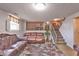 Spacious basement featuring new flooring, comfortable seating and staircase to upper level at 3535 Ivory Way, Indianapolis, IN 46227