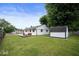 Expansive backyard with deck, lush lawn, and a storage shed at 3864 Esquire Ct, Indianapolis, IN 46226