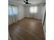 An empty bedroom with hardwood floors, ceiling fan, and well-lit by two windows at 3864 Esquire Ct, Indianapolis, IN 46226