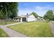 Beautiful home with a green lawn, a driveway leading to a garage, and a light-colored fence at 3864 Esquire Ct, Indianapolis, IN 46226