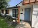 Charming home exterior featuring a blue front door, fresh white siding, and a cozy pergola at 3864 Esquire Ct, Indianapolis, IN 46226