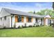 Well-maintained single-story home featuring updated black trim, wooden shutters, and landscaped yard at 3864 Esquire Ct, Indianapolis, IN 46226
