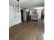 Open-concept kitchen with stainless steel appliances, island, and modern lighting at 3864 Esquire Ct, Indianapolis, IN 46226