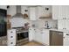 Stylish kitchen featuring stainless steel appliances, white cabinetry, and open shelving at 3864 Esquire Ct, Indianapolis, IN 46226