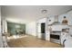 Open kitchen with stainless steel appliances, white cabinets, and seamless flow to dining area at 3864 Esquire Ct, Indianapolis, IN 46226