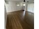 Spacious living room with vinyl flooring, white wainscoting, and ample natural light at 3864 Esquire Ct, Indianapolis, IN 46226