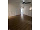 Open-concept living room with vinyl floors, white wainscoting, and modern ceiling fan at 3864 Esquire Ct, Indianapolis, IN 46226