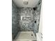 A close-up of the newly tiled walk-in shower with a built in shower caddy at 3864 Esquire Ct, Indianapolis, IN 46226