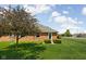 Brick home showcasing a beautiful manicured lawn, complemented by mature trees at 389 Vinewood N Dr, Brownsburg, IN 46112