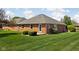 Home featuring a well-manicured lawn and backyard patio at 389 Vinewood N Dr, Brownsburg, IN 46112