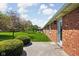 Spacious backyard with well-maintained lawn, trees, and brick exterior at 389 Vinewood N Dr, Brownsburg, IN 46112