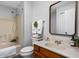Well-lit bathroom featuring wood cabinets, and combined shower and bathtub at 389 Vinewood N Dr, Brownsburg, IN 46112