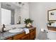 Well-lit bathroom featuring wood cabinets, granite countertops, a decorative mirror, and modern fixtures at 389 Vinewood N Dr, Brownsburg, IN 46112