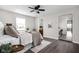 Bright bedroom featuring a ceiling fan, a large window, and an ensuite bathroom at 389 Vinewood N Dr, Brownsburg, IN 46112