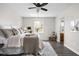 Inviting bedroom bathed in light, featuring a ceiling fan, a window with green views and an ensuite bathroom at 389 Vinewood N Dr, Brownsburg, IN 46112