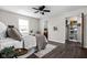 Sun-drenched bedroom featuring a ceiling fan, a large window, walk-in closet, and an ensuite bathroom at 389 Vinewood N Dr, Brownsburg, IN 46112