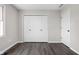 Charming bedroom featuring a large closet, a door to another room, a window and hardwood flooring at 389 Vinewood N Dr, Brownsburg, IN 46112