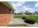 Backyard of charming brick home with manicured lawn and back door at 389 Vinewood N Dr, Brownsburg, IN 46112