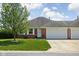 Charming brick home featuring a well-maintained lawn, mature tree, and attached two-car garage at 389 Vinewood N Dr, Brownsburg, IN 46112