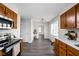 Well-lit kitchen featuring wood cabinets, white countertops, stainless steel appliances, and hardwood flooring at 389 Vinewood N Dr, Brownsburg, IN 46112