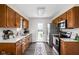 Functional kitchen featuring wood cabinetry, stainless steel appliances, white countertops, and a view to the back yard at 389 Vinewood N Dr, Brownsburg, IN 46112