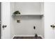 Bright laundry area featuring wood floors and a built-in shelf for storage at 389 Vinewood N Dr, Brownsburg, IN 46112