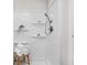 Clean, bright shower featuring modern fixtures, built-in shelving and a rattan stool with fresh towels at 389 Vinewood N Dr, Brownsburg, IN 46112