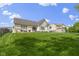 Back exterior featuring a sprawling, well-manicured lawn and partial deck at 3965 Andretti Dr, Zionsville, IN 46077