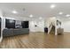 Finished basement boasts wood floors, a cozy seating area, and staircase at 3965 Andretti Dr, Zionsville, IN 46077