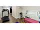 Basement area with workout space, mirror, and storage, all with wood flooring at 3965 Andretti Dr, Zionsville, IN 46077
