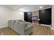 Cozy basement with stylish accent wall, comfortable seating, and attractive wood-look flooring at 3965 Andretti Dr, Zionsville, IN 46077