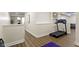 Basement landing space featuring exercise equipment and view into adjacent room at 3965 Andretti Dr, Zionsville, IN 46077