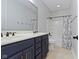 Bathroom with a double sink vanity with decorative fixtures and a bathtub with shower at 3965 Andretti Dr, Zionsville, IN 46077