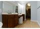 Bathroom with dual vanity and a large mirror leading to a walk in closet at 3965 Andretti Dr, Zionsville, IN 46077
