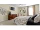 A light-filled bedroom boasts a dresser, comfortable chair, and neutral walls and carpet at 3965 Andretti Dr, Zionsville, IN 46077